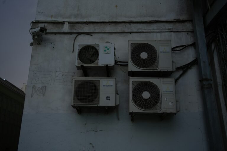 A group of speakers mounted to the side of a building